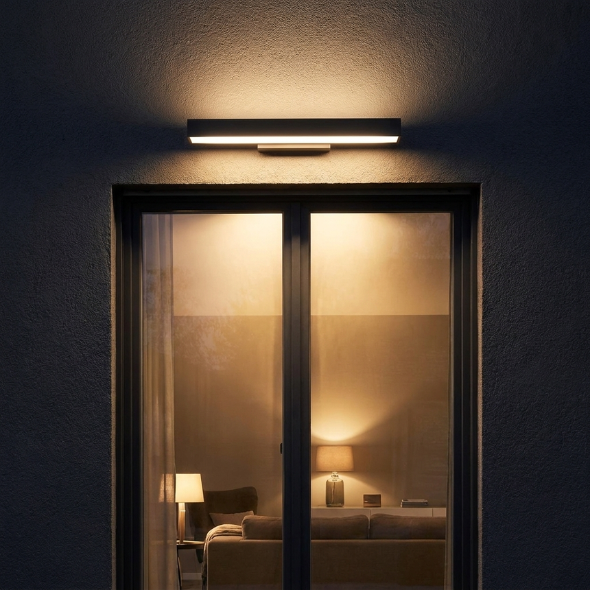 Rectangular LED light above a window on a dark facade at night